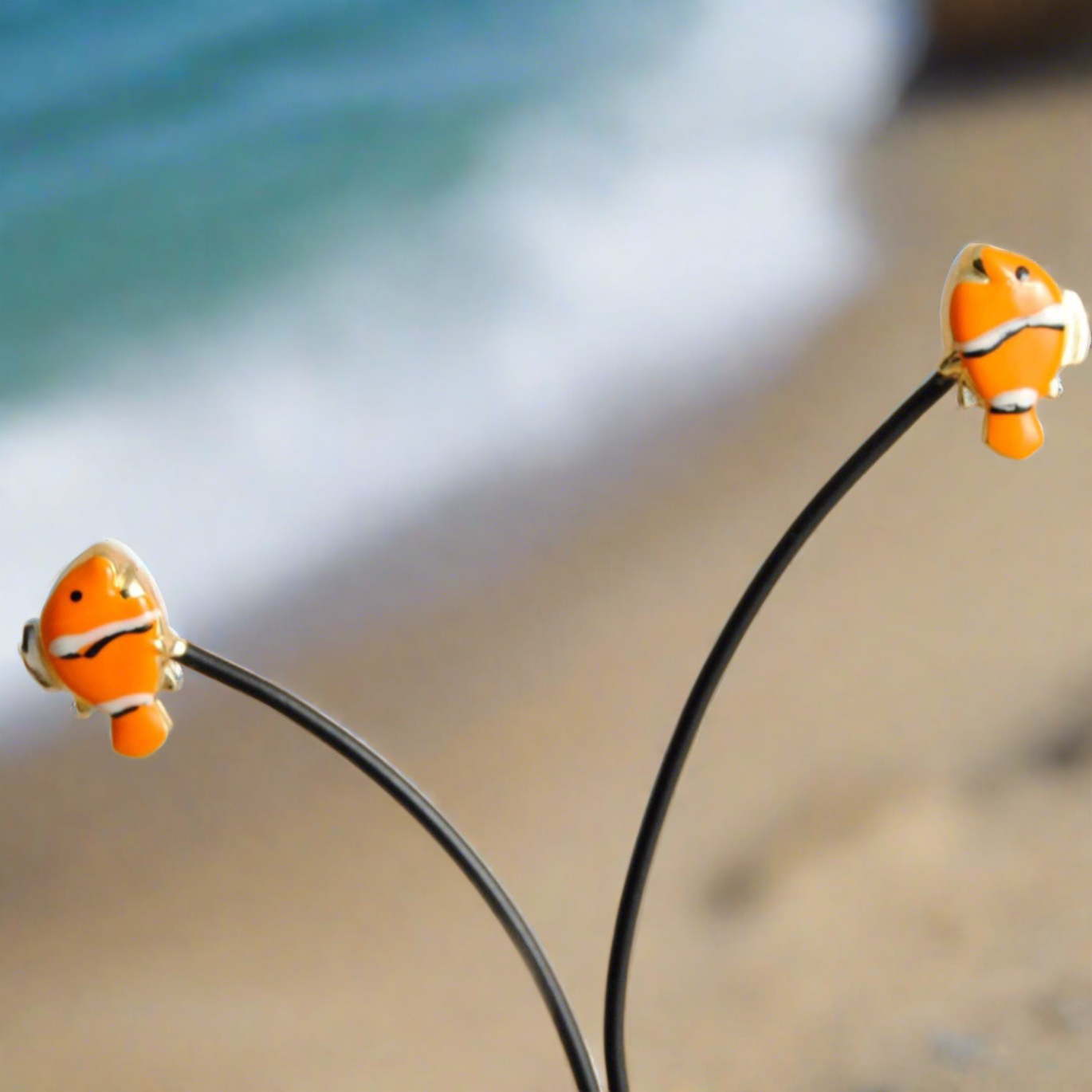 18K gold earrings feature a playful fish-nemo adorned with vibrant enamel