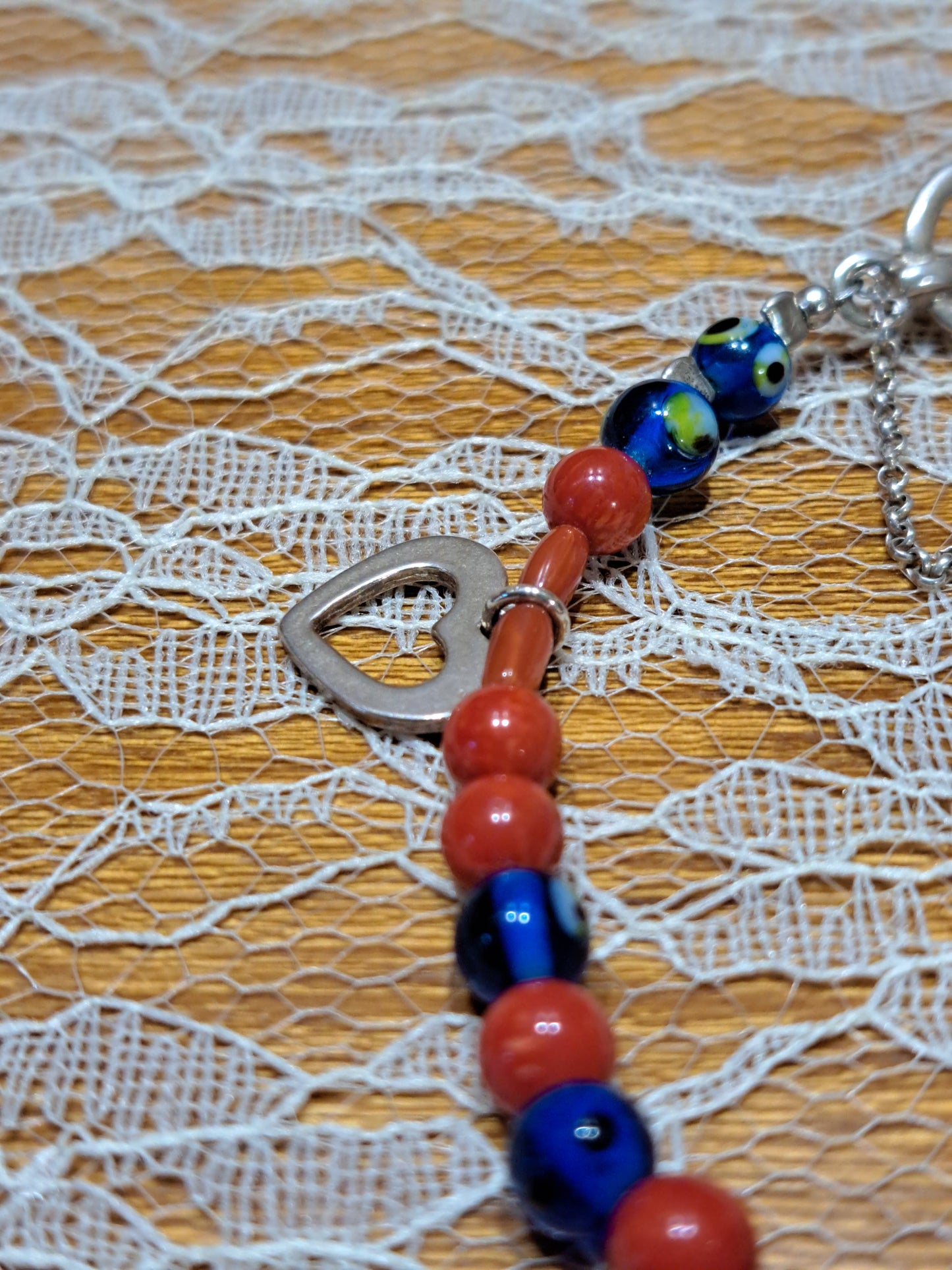 Handmade sterling silver bracelet with corals a heart and evil eyes