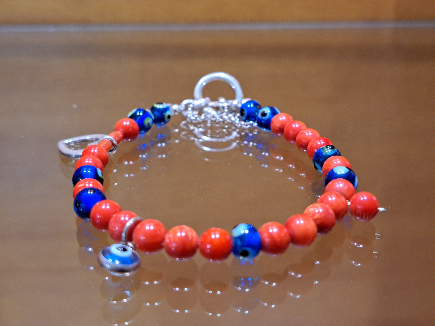 Handmade sterling silver bracelet with corals a heart and evil eyes
