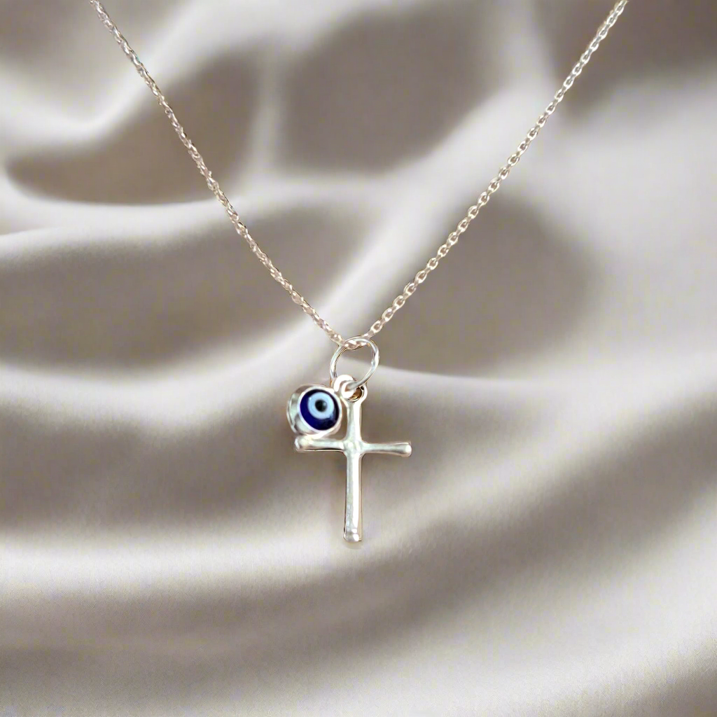 Sterling silver tiny cross with an evil eye