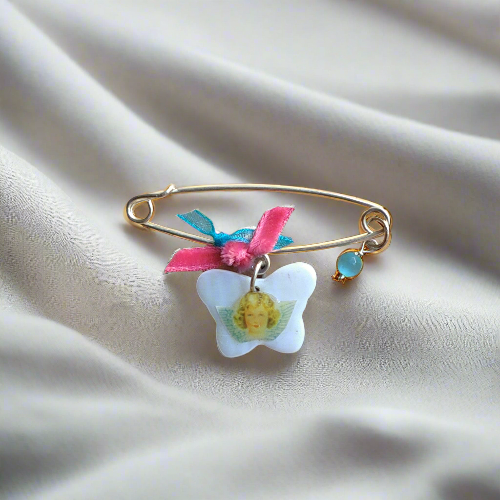 Handmade sterling silver baby pin with an angel