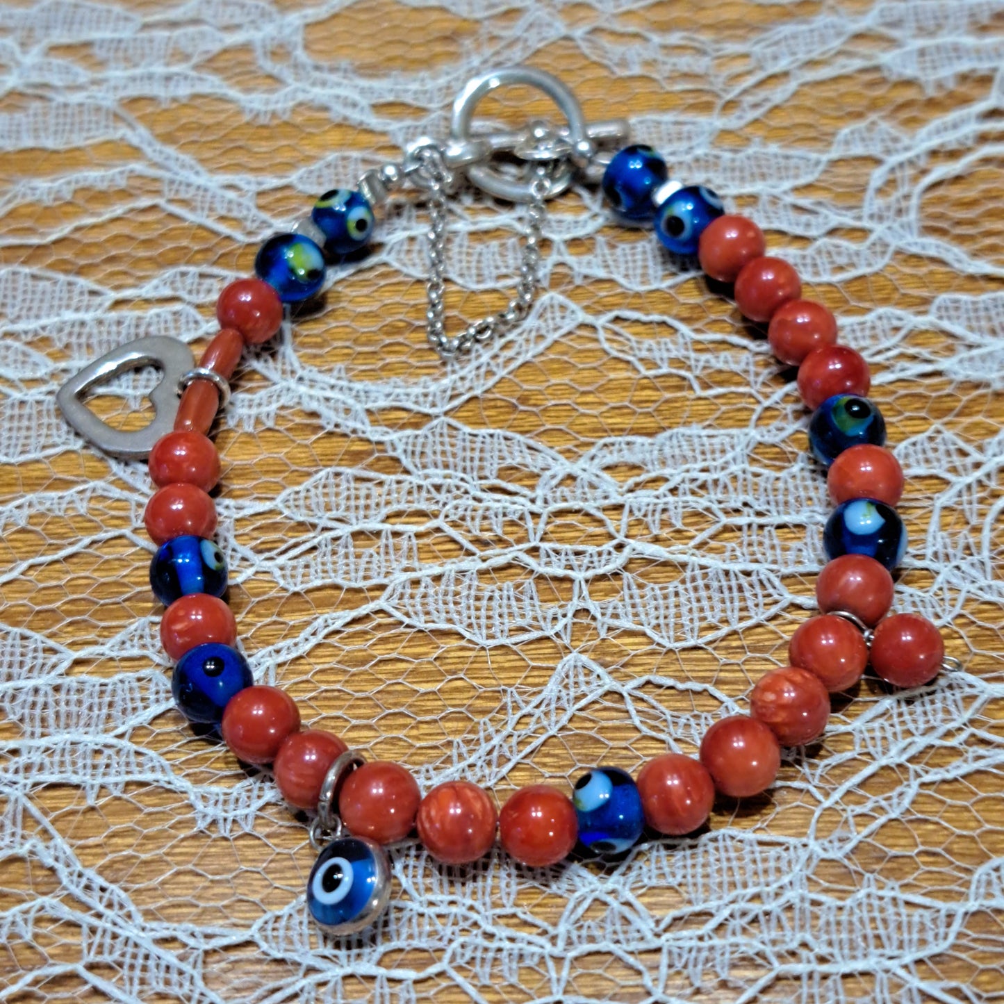 Handmade sterling silver bracelet with corals a heart and evil eyes