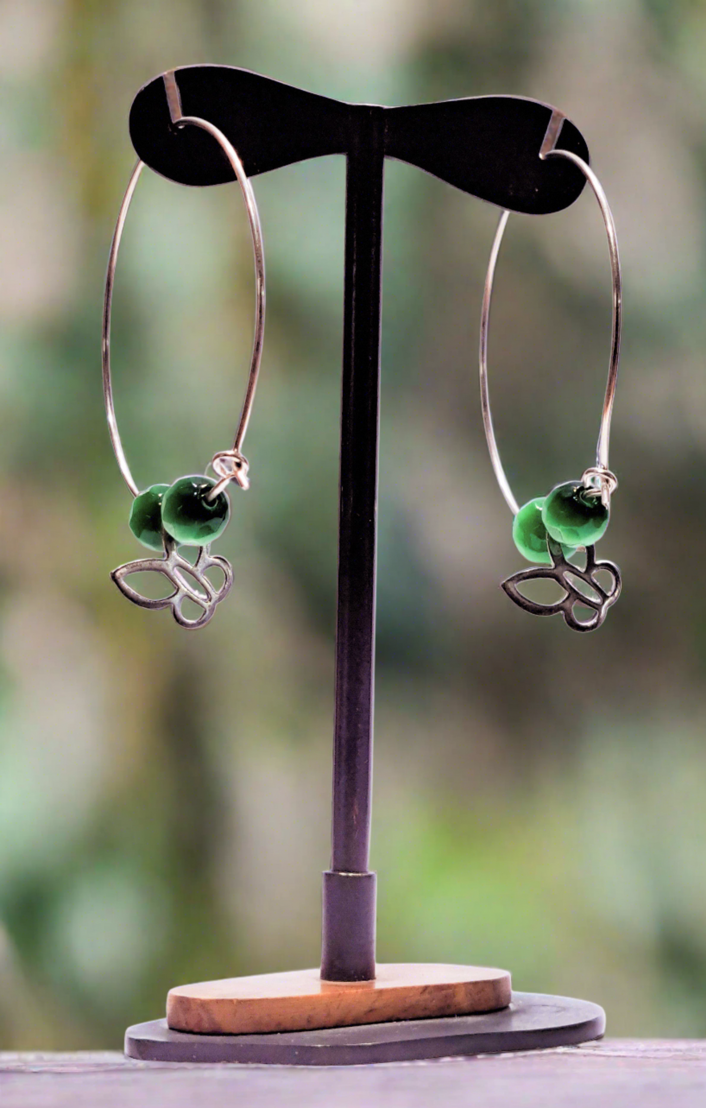 Handmade sterling silver hoops with green beads and butterfies