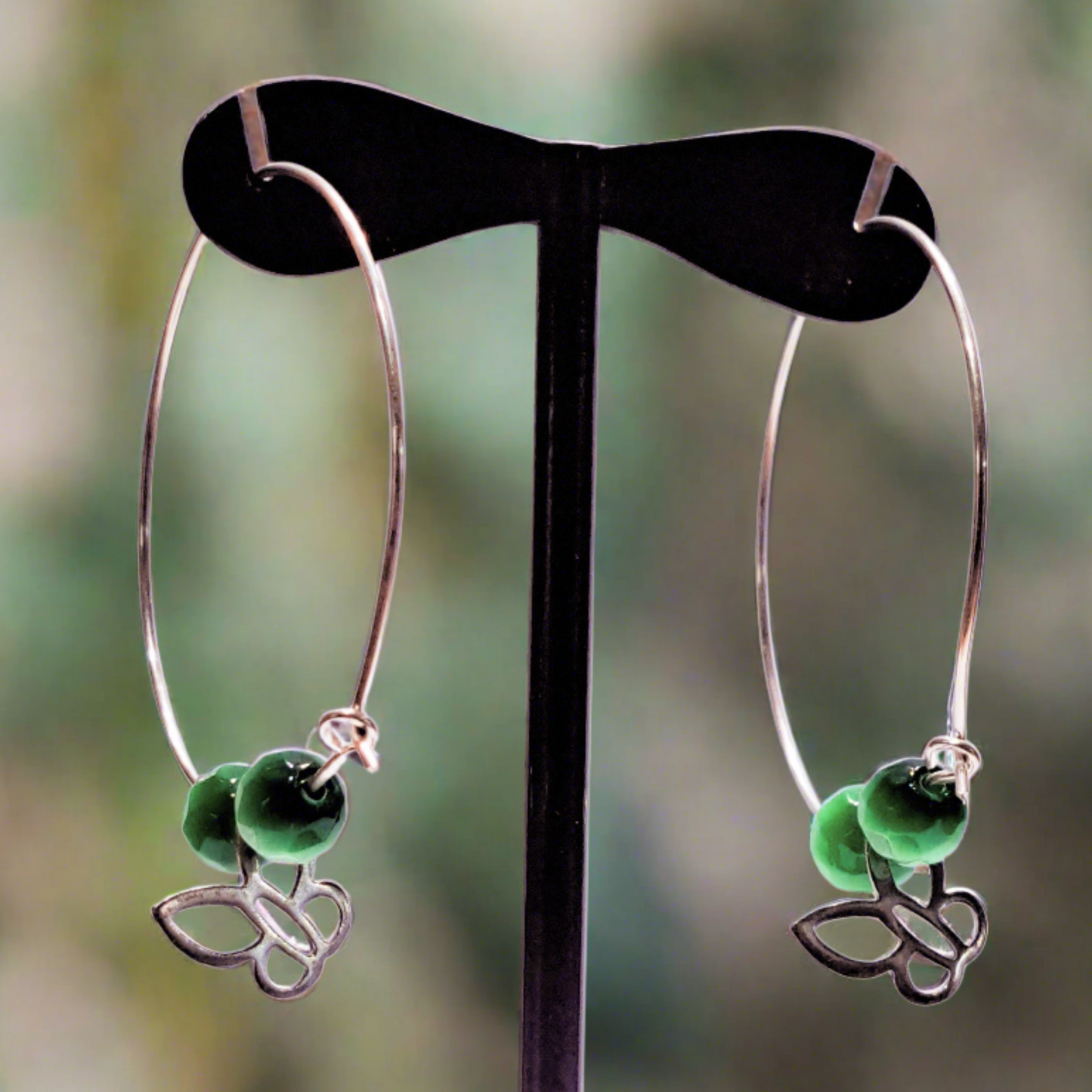 Handmade sterling silver hoops with green beads and butterfies