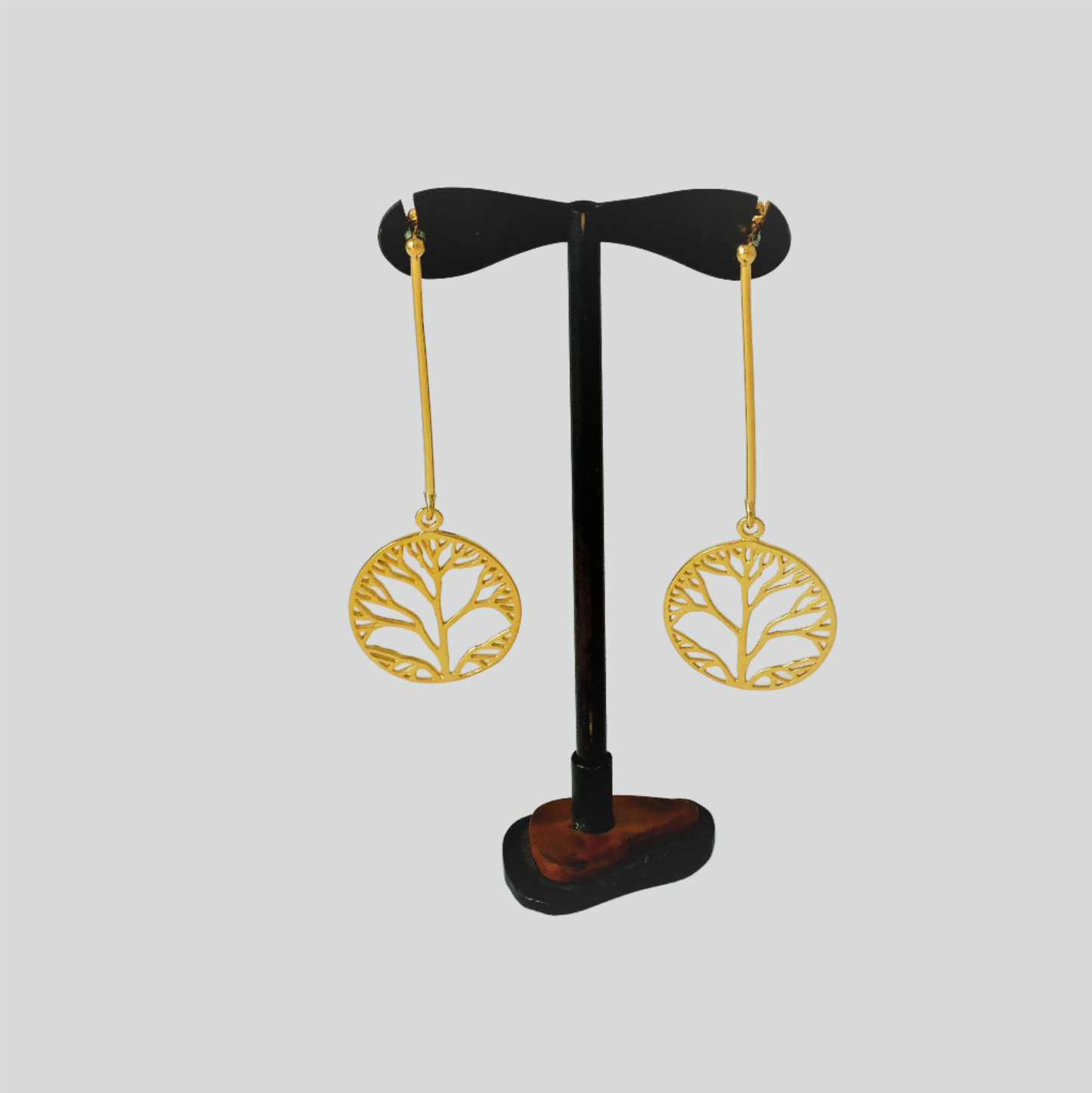-“Earrings made of silver, gold-plated, long with thick wire, and beneath the wire hangs a round design with the tree of life. The design is perforated and elegant.”