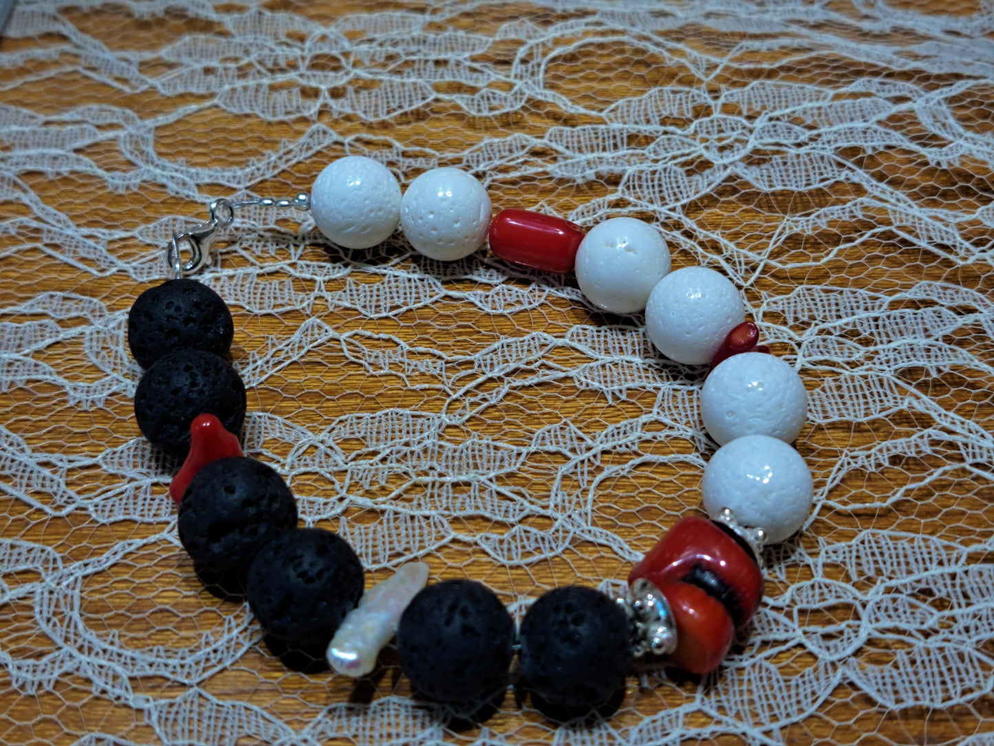 Bracelet with lava beads white  corals and red corals and silver.
