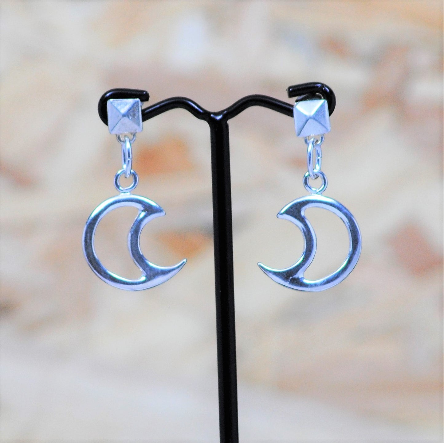Silver earrings with moons .