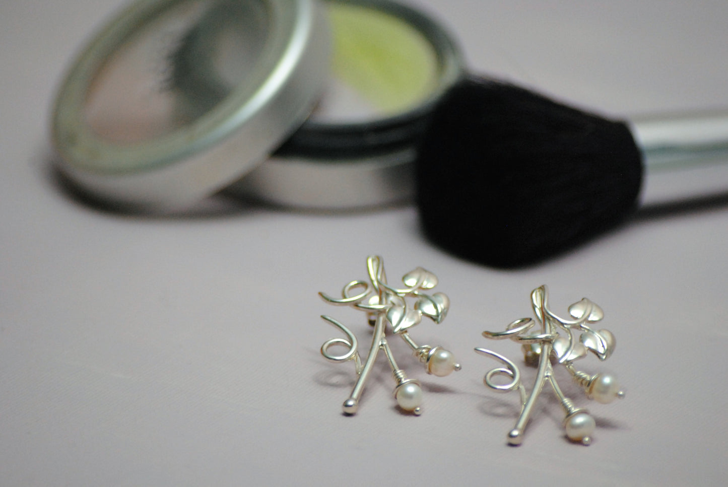 Sterling silver stud earrings with pearls represent ivy