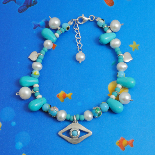 Evil eye bracelet with turqoise pearls and silver