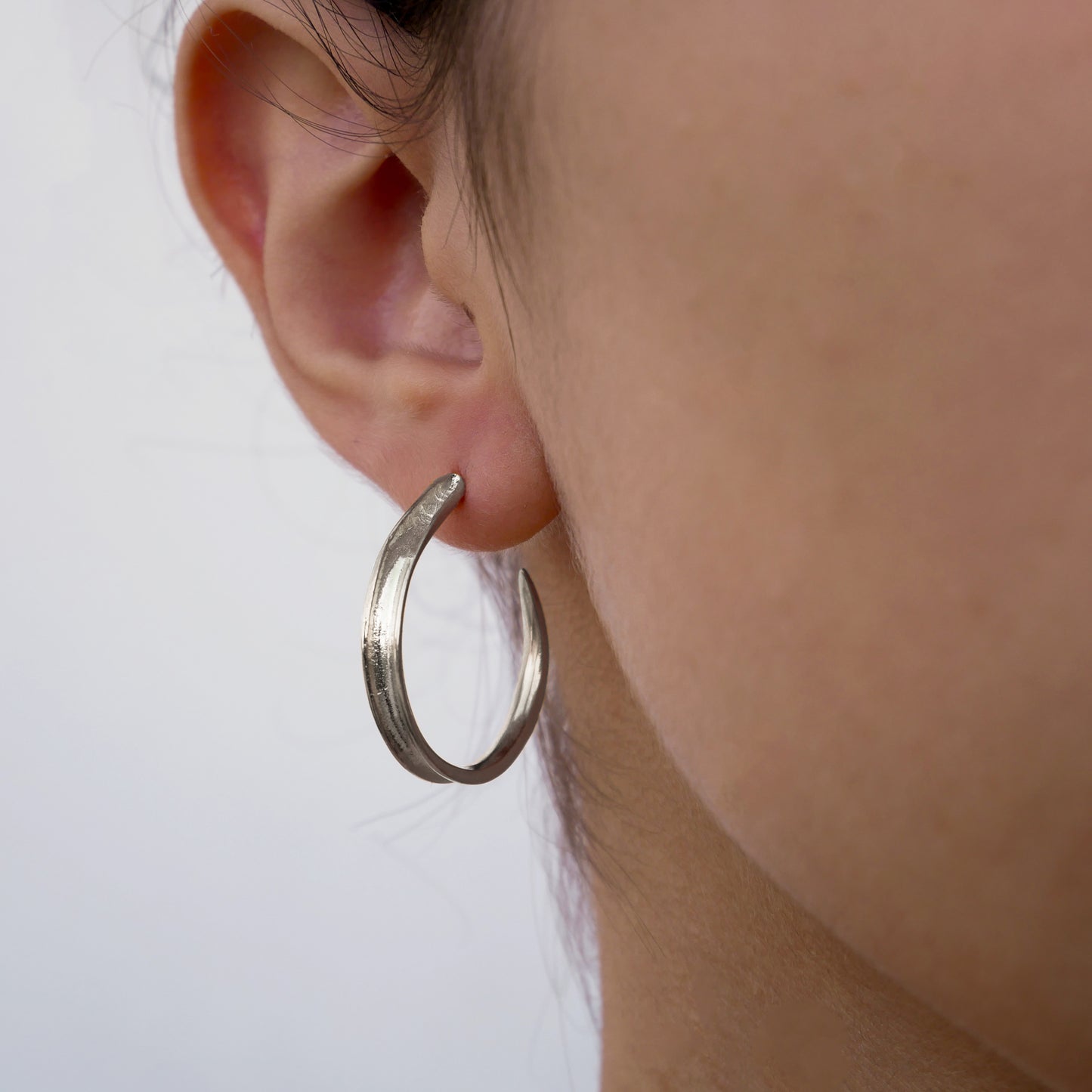 Leaf -Silver hoops look like leaves in a girl's face