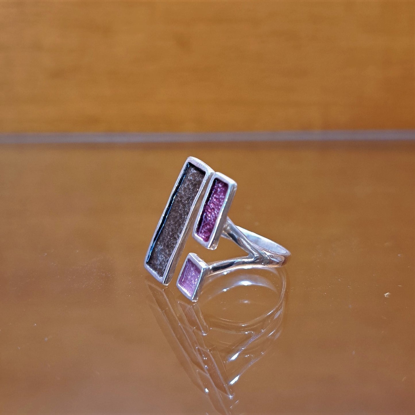 Silver ring with grey and purple enamel.