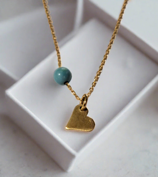 14K gold necklace with a tiny heart and a blue turqoise gem