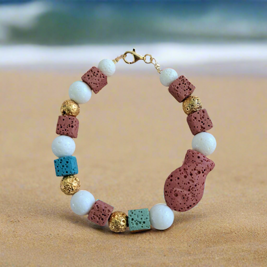 Handmade bracelet with white corals, lawa beads and goldplated sterling silver elements.