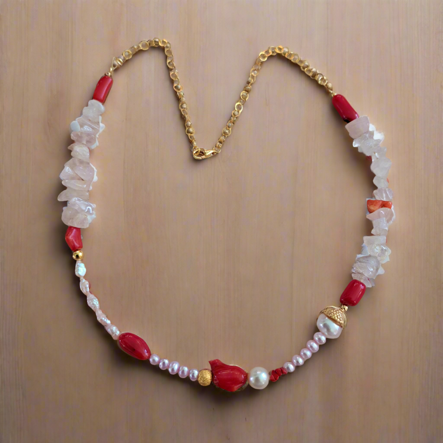 Handmade necklace with corals, pearls, and quartz with gold plated sterling silver.