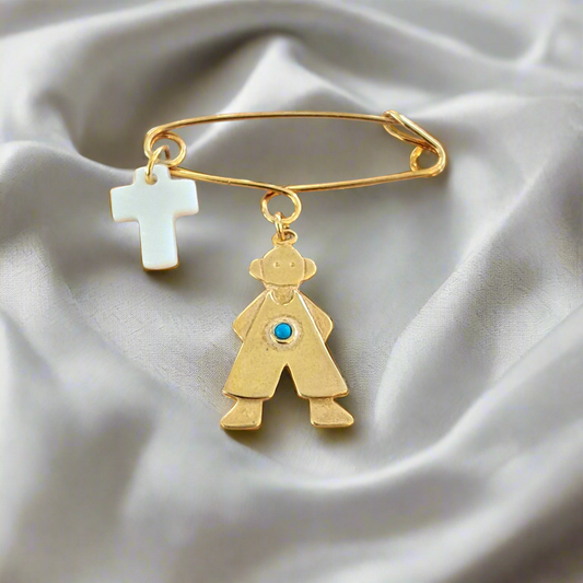 Handmade gold plated silver pin with a boy and a mother of pearl cross