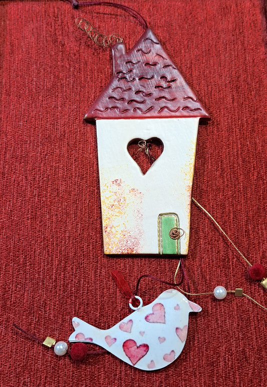 Handmade ceramic house with a big heart and a bird