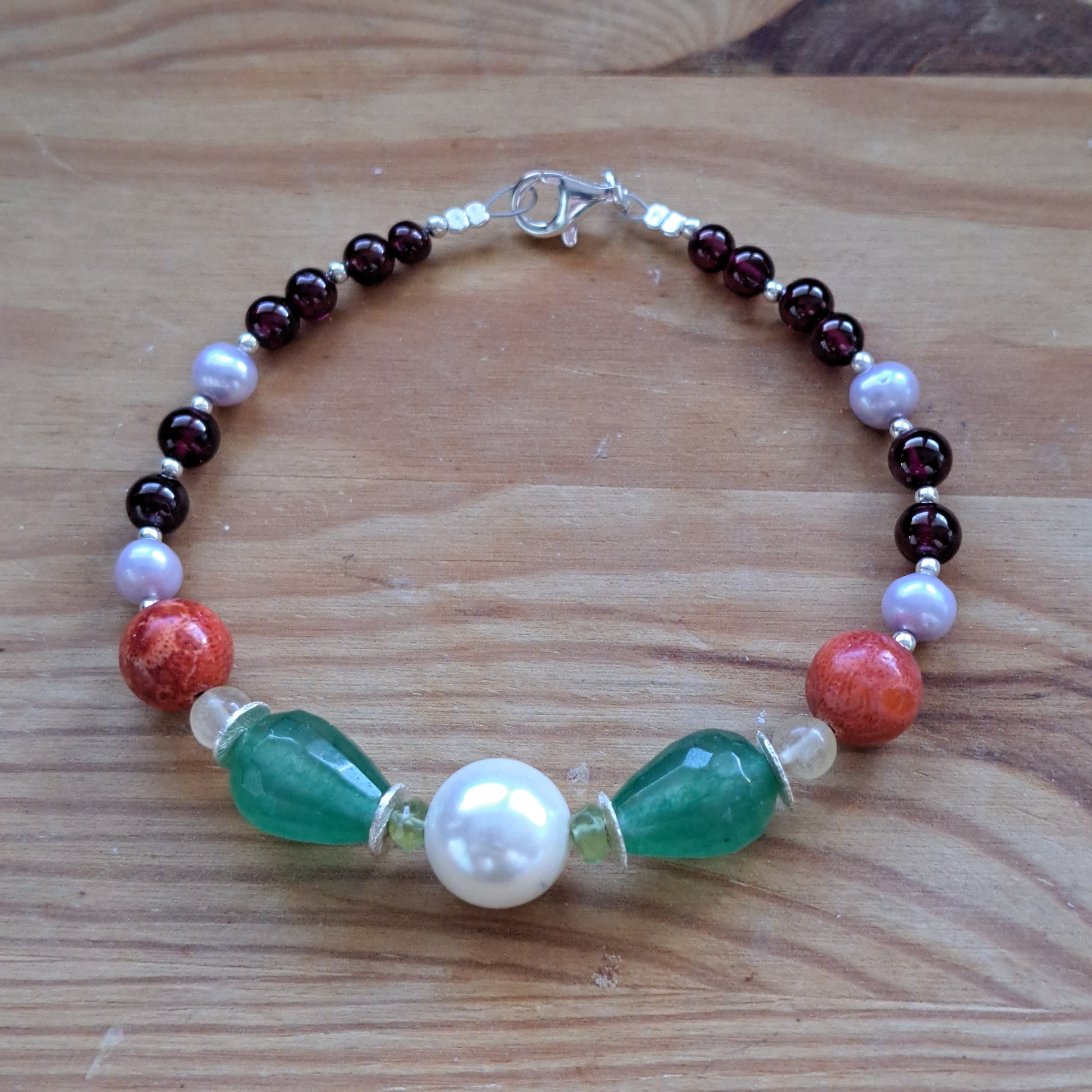 Handmade bracelet with sterling silver garnets,pearls,corals and green agates. - Katerina Roukouna