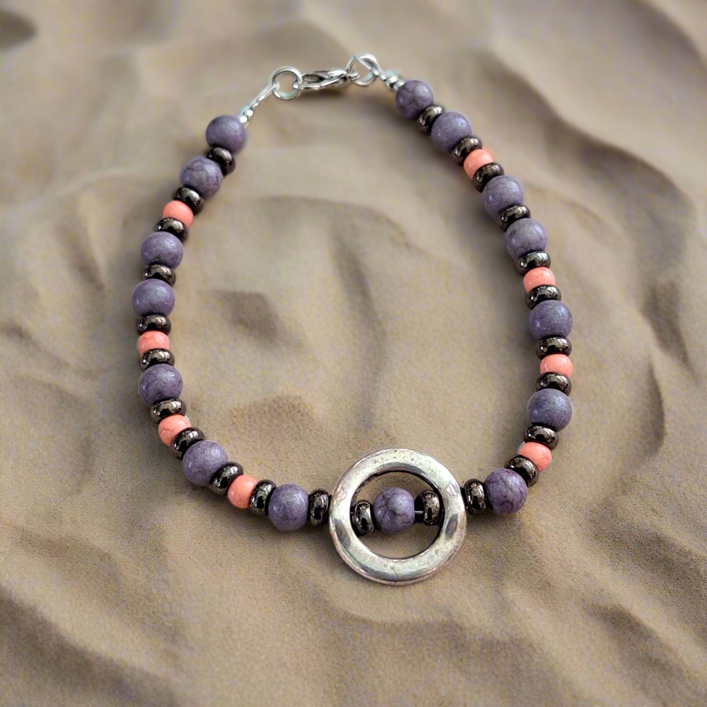 Bracelet with purple, pink  haolite beads and german silver elements .