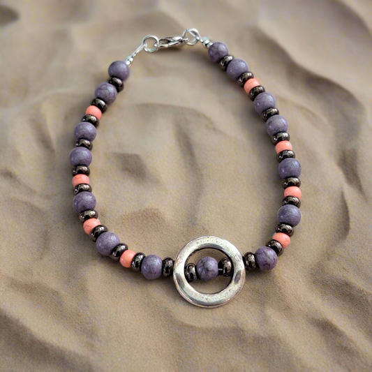 Bracelet with purple, pink  haolite beads and german silver elements .