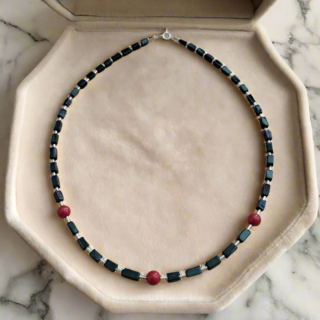Handmade necklace with stelring silver, onyx and corals.