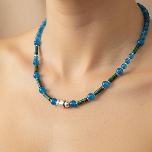 Necklace with blue agates ,green malachites and sterling silver on a woman's  neck against a beige background