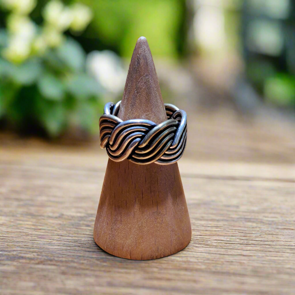 Ring made by brass and silver in a wooden surface
