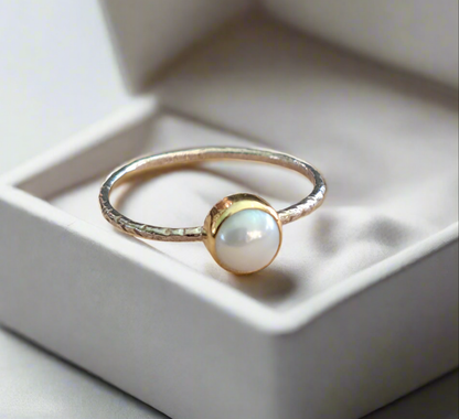 Handmade sterling silver ring with 18K gold and a pearl.