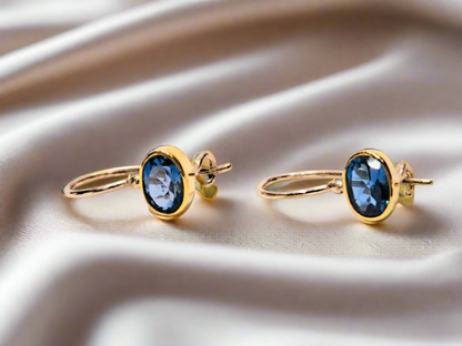 Handmade earrings with 18K gold and silver with blue topaz