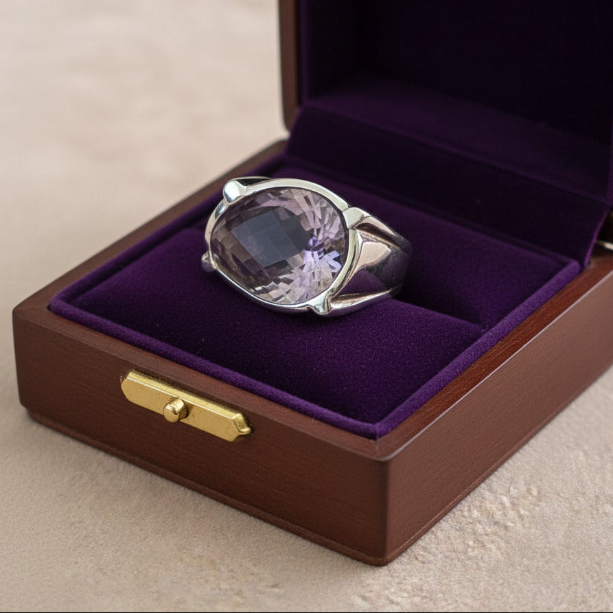 Silver ring with a purple  amethyst gemstone in a jewelry box