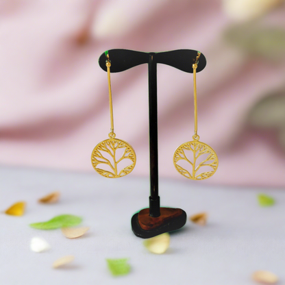 Tree of life long earrings in a stand. Earrings made of silver, gold-plated, long with thick wire, and beneath the wire hangs a round design with the tree . The design is perforated and elegant.”