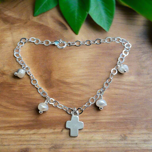 Handmade sterling silver bracelet with a cross and pearls.