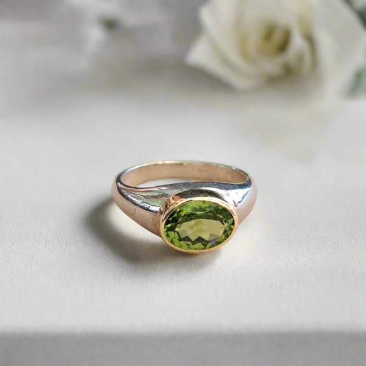 Handmade  sterling silver and 18K gold ring with oval peridot.