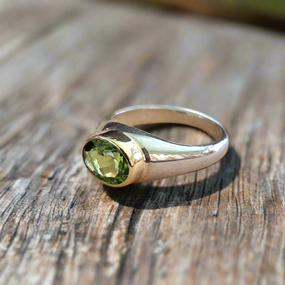 Handmade  sterling silver and 18K gold ring with oval peridot.