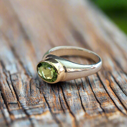 Handmade  sterling silver and 18K gold ring with oval peridot.