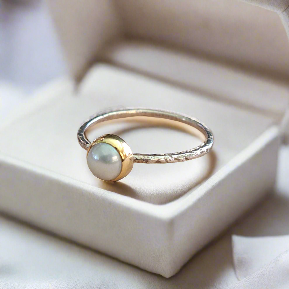 Handmade sterling silver ring with 18K gold and a pearl.