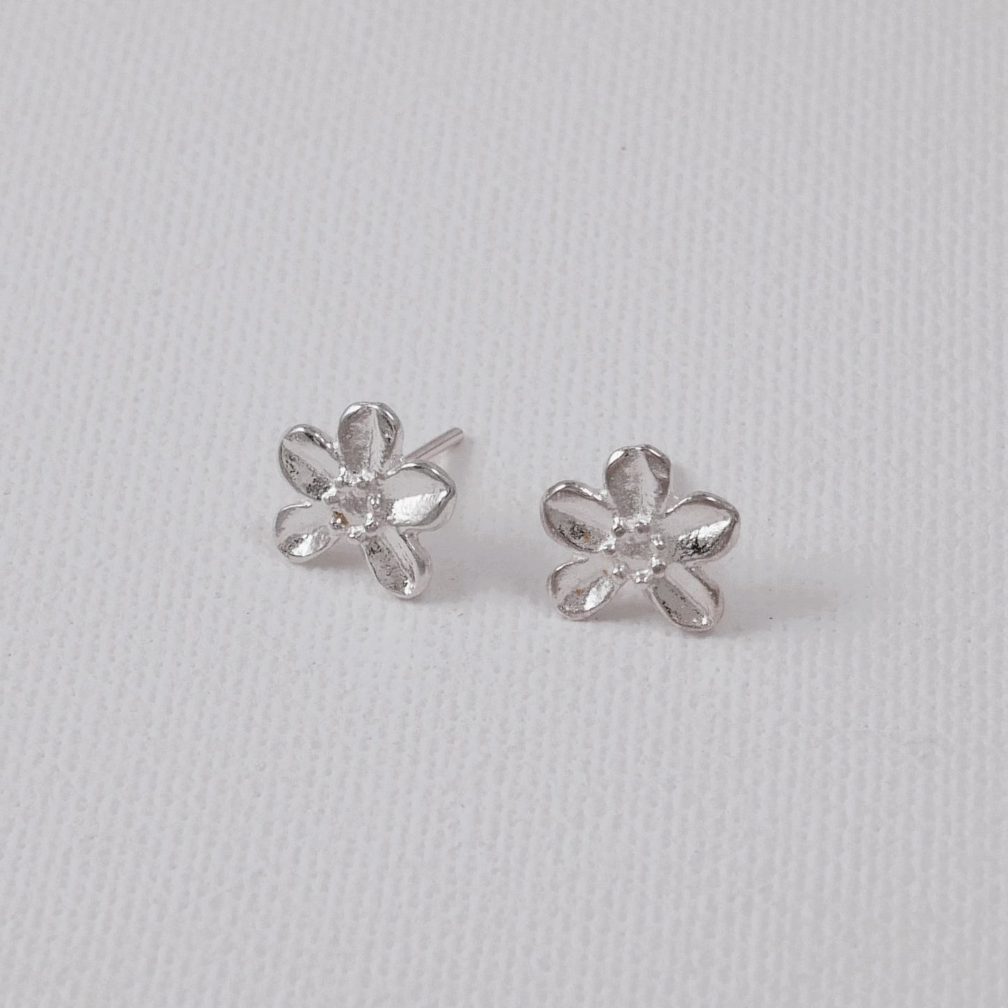 Tiny stud  silver earrings with a small flower 