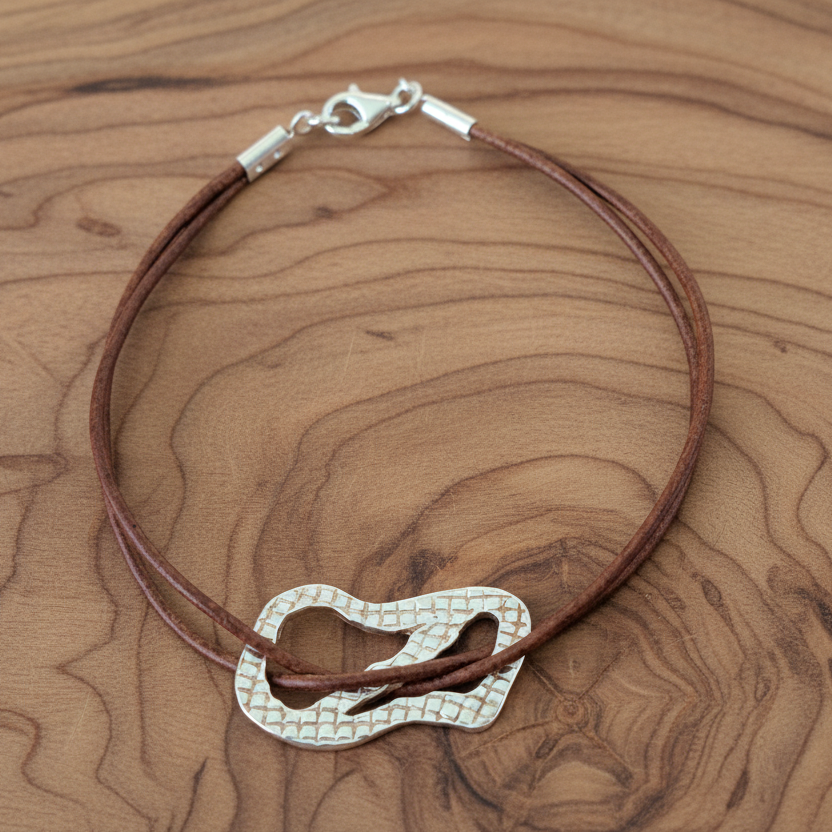 Handmade textured sterling silver bracelet with leather. - Katerina Roukouna