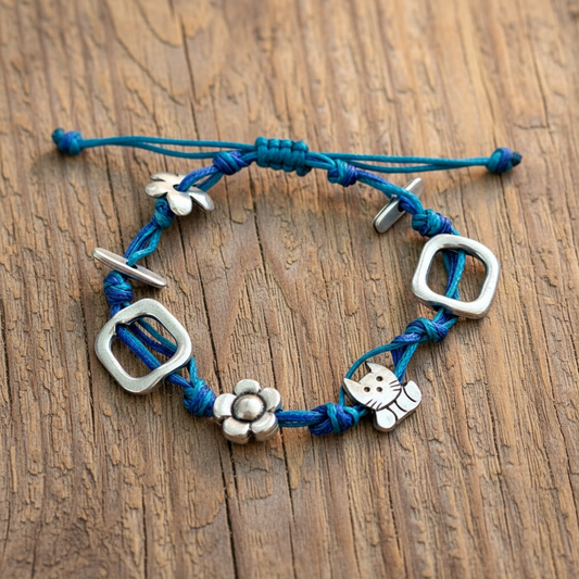 Handmade bracelet with blue cords a cut and a flower - Katerina Roukouna