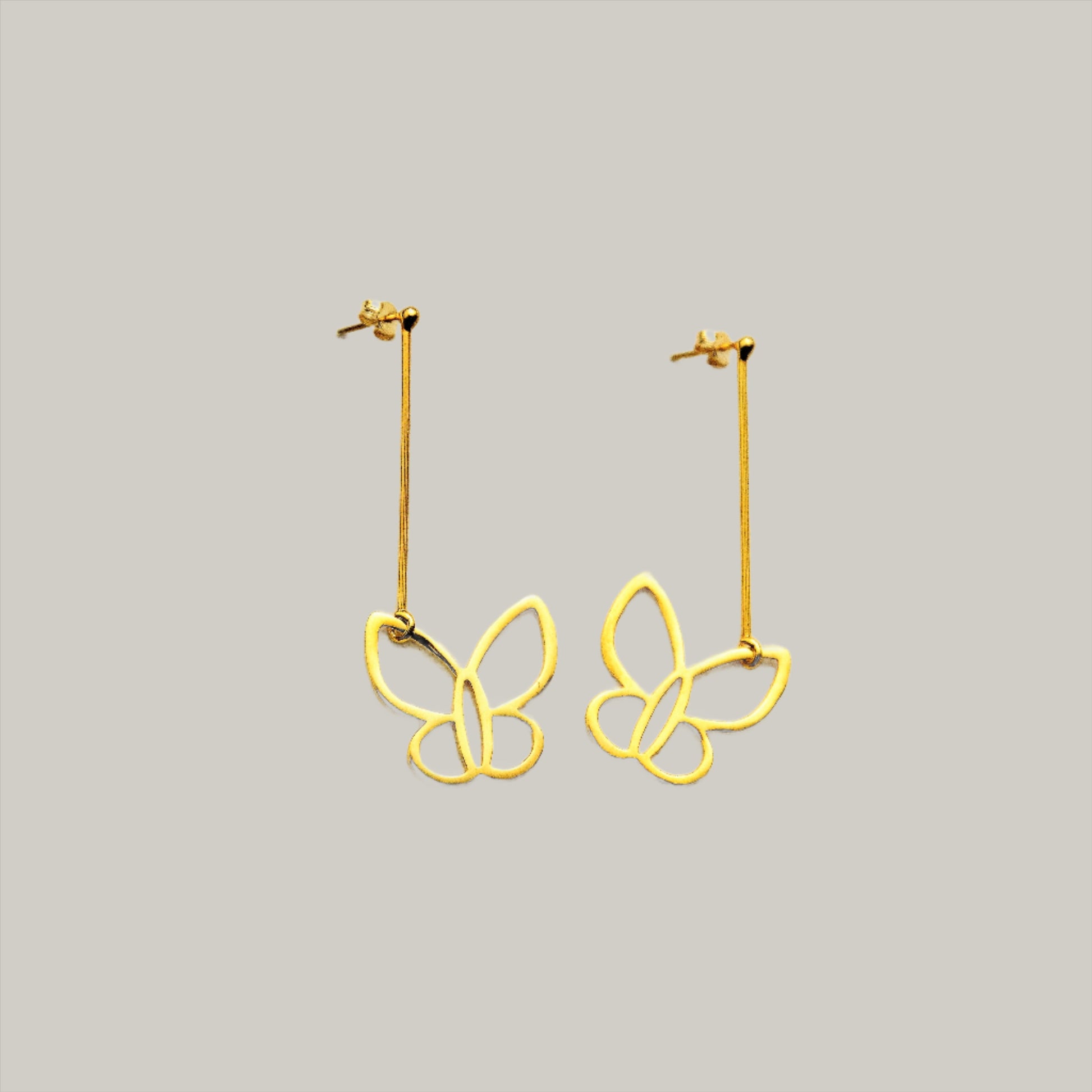 Butterflies gold plated silver earrings. The earringw made by a long massive wire hangs a butterfly.