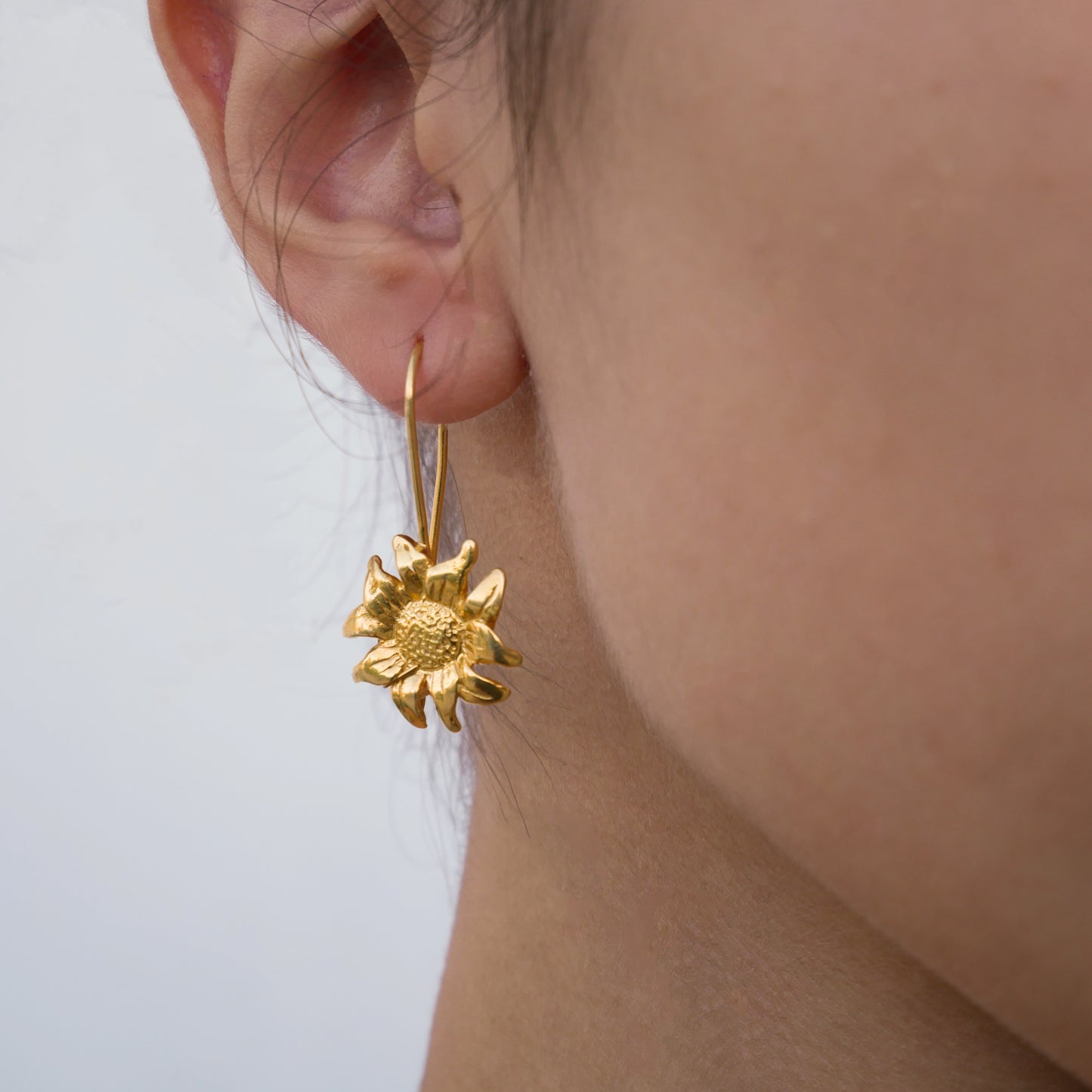 Helianthus - gold plated silver earrings  in a face