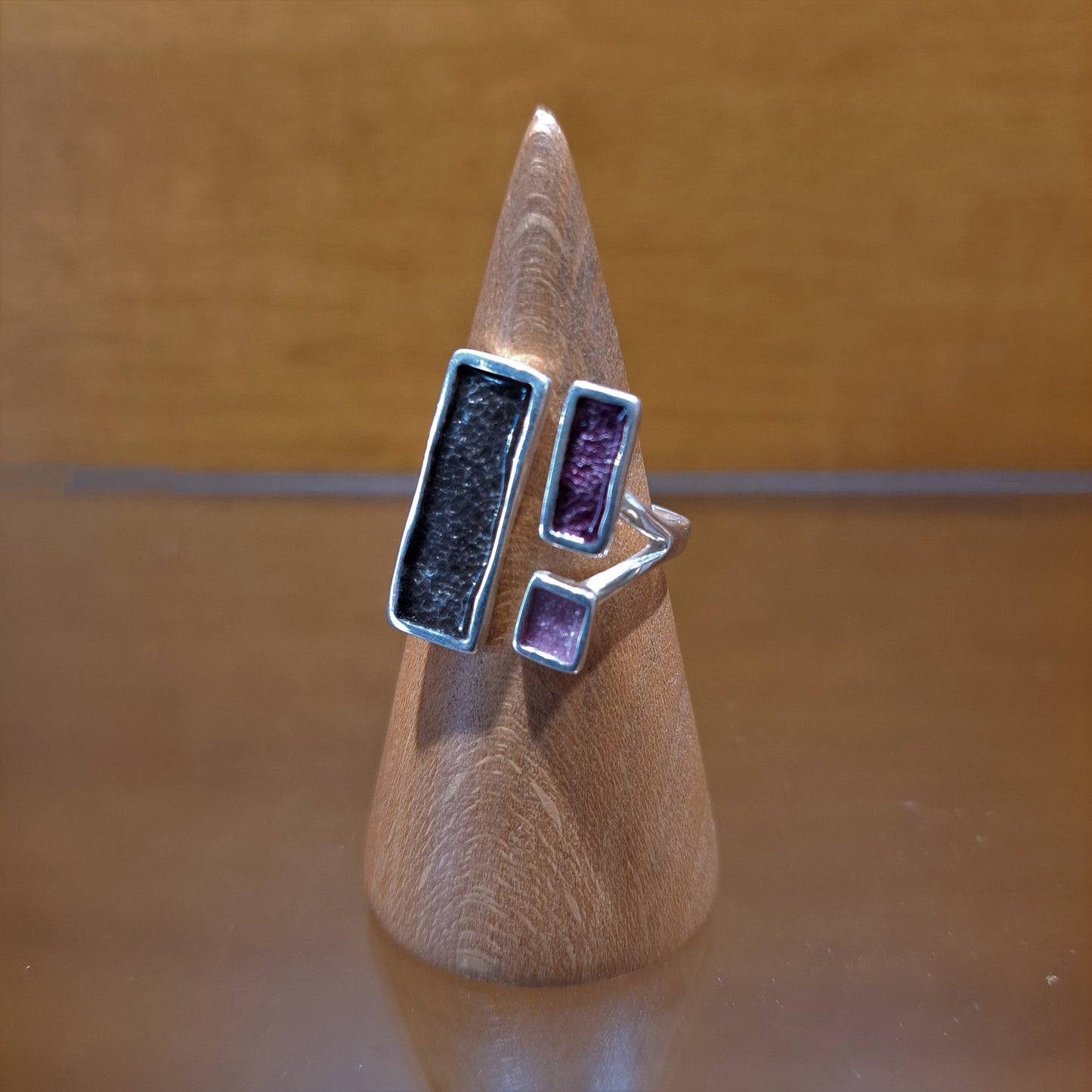 Silver ring with grey and purple enamel.